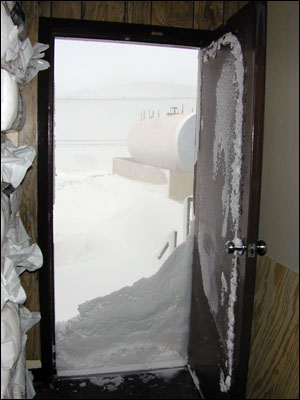 Snow piled up outside the door