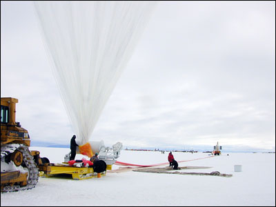 Beginning to inflate the balloon. The rest of the 
												 balloon is stretched out all the way to the payload 
												 hanging from the crane in the far distance