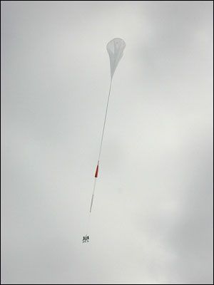 The balloon flying up with the payload